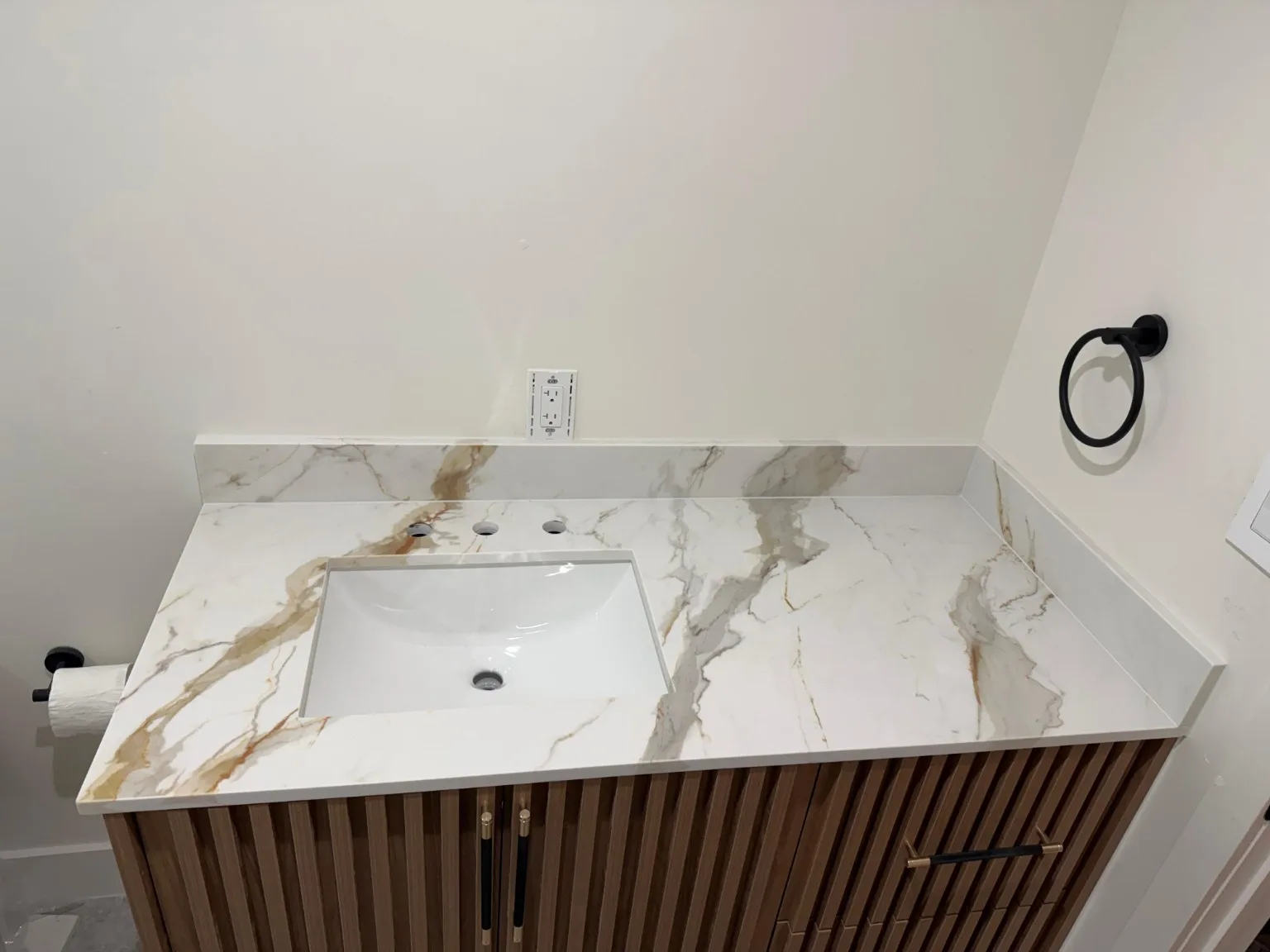 Wood vanity with stone countertop and undermount sink