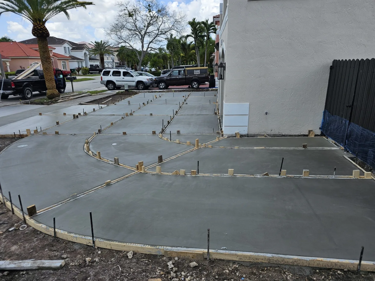 Concrete driveway forms and curved sections set alongside the house during construction