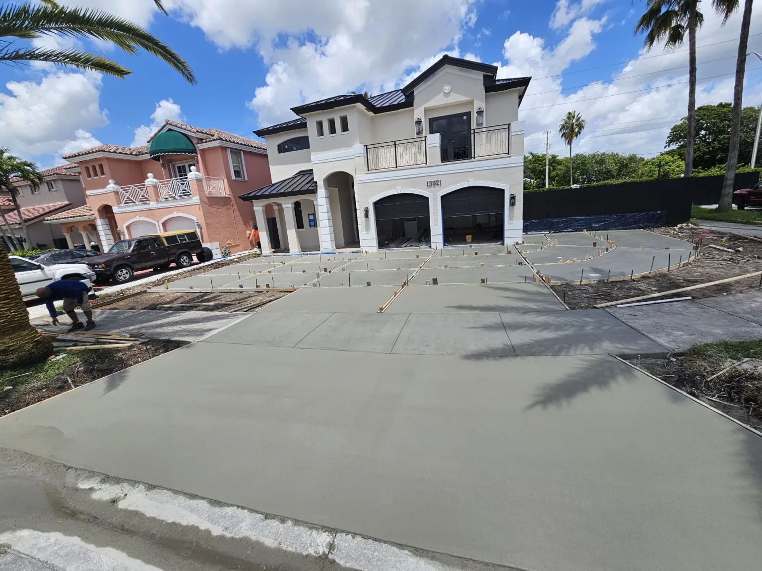 Newly finished decorative concrete driveway being detailed