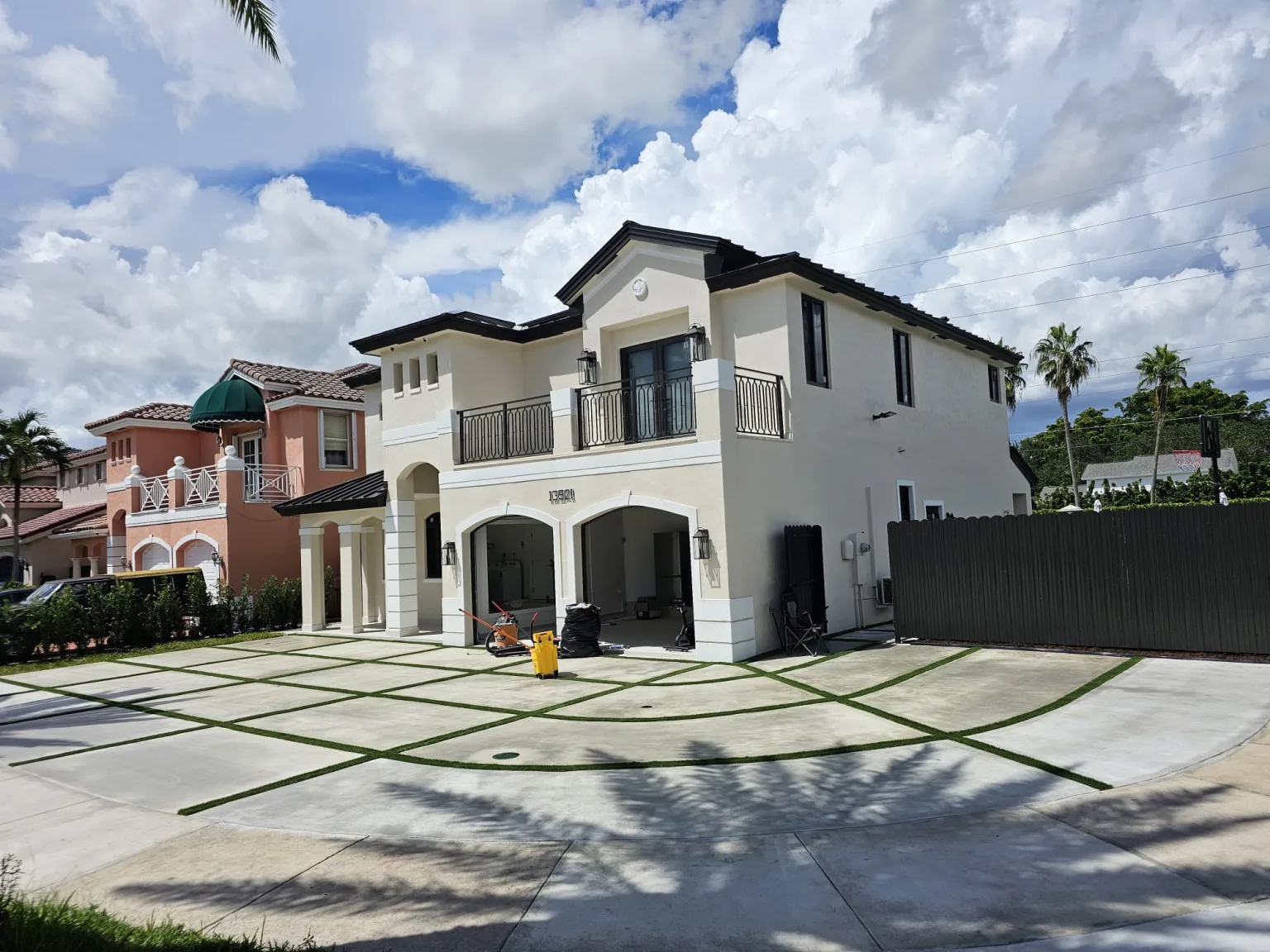Finished Miami home exterior with a newly poured concrete driveway completed by JT Express Solutions