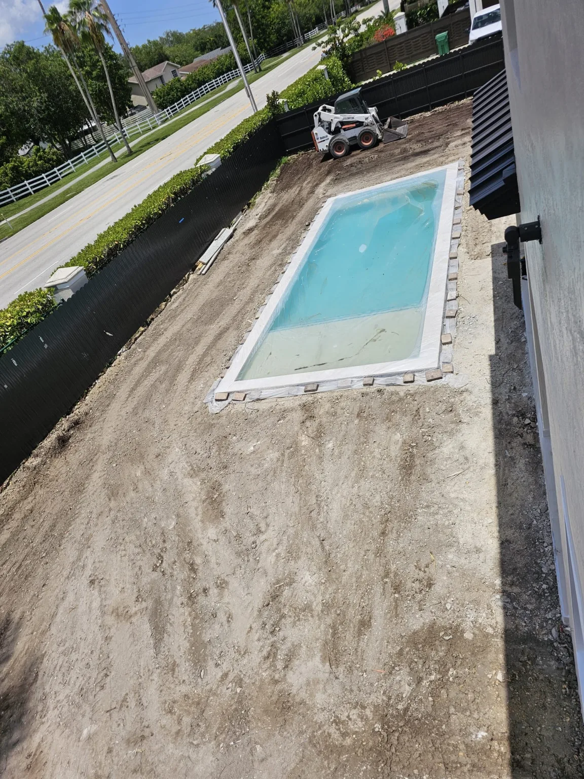 Backyard during construction with excavation equipment on site