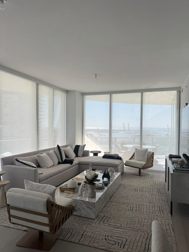 Floor-to-ceiling solar roller shades installed in a Miami living room by JT Express Solutions
